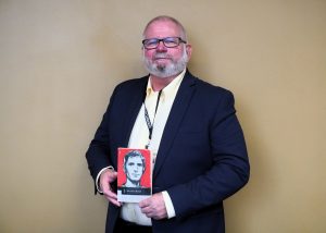 Victor DeLong holding book "On the Road"